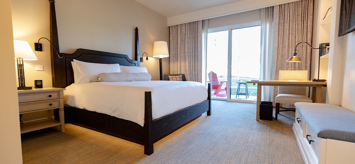 Bed and desk area in a King Terrace room at The Inn