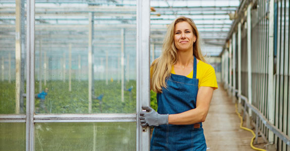 Woman standing in a greenhouse