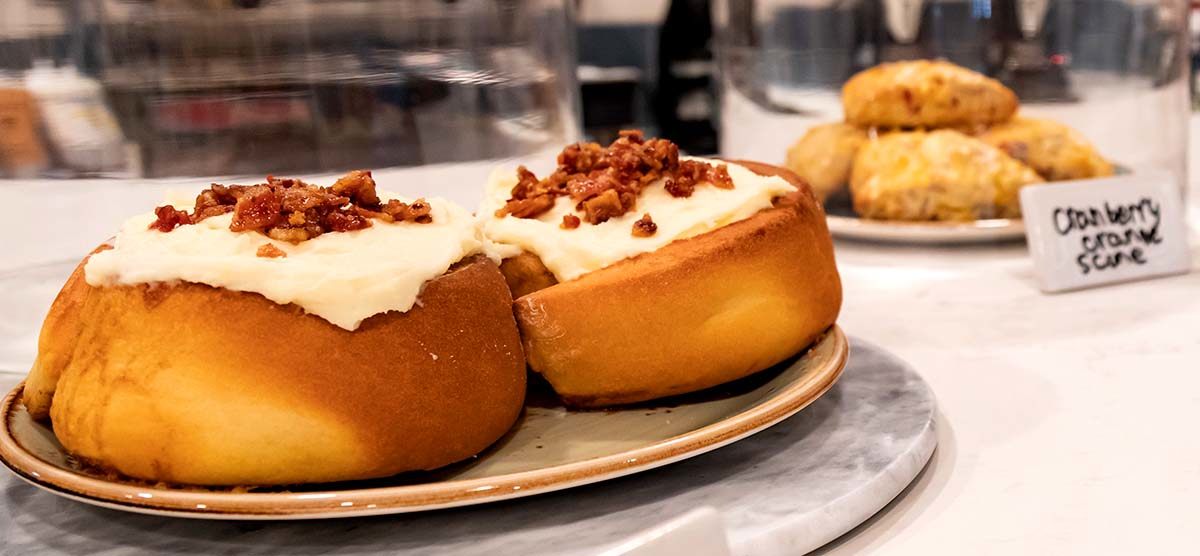 Cinnamon rolls topped with bacon for purchase at the Library Café