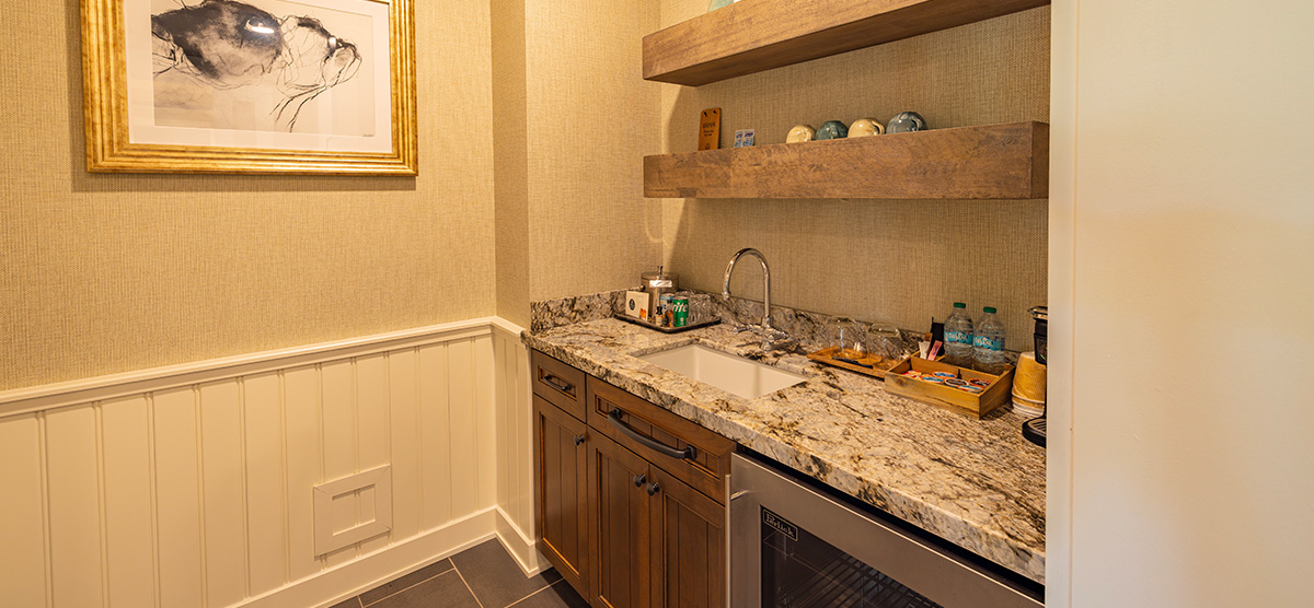 carousel-executive-king-suite-1br-5-1200x556 Wet bar with sink and mini fridge.
