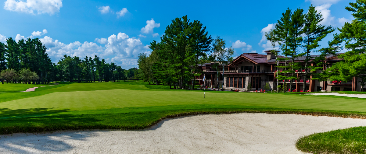 Sand trap next to a putting green behind The Inn at SentryWorld