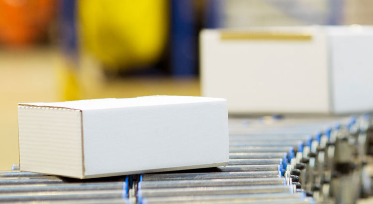 Boxes on distribution line in warehouse