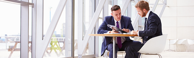 Two business people seated in meeting