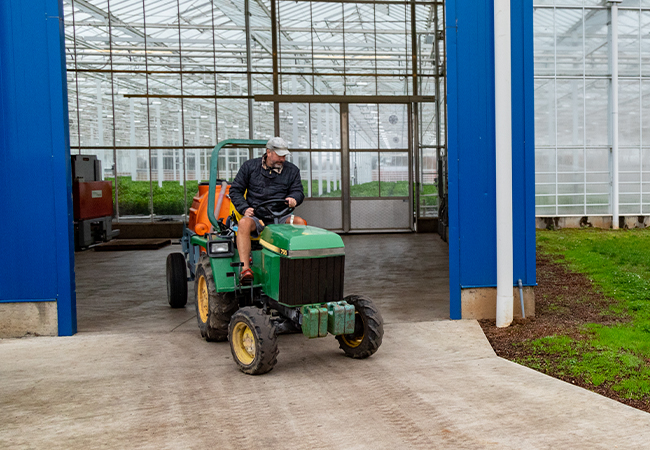 A man riding a John Deere tractor