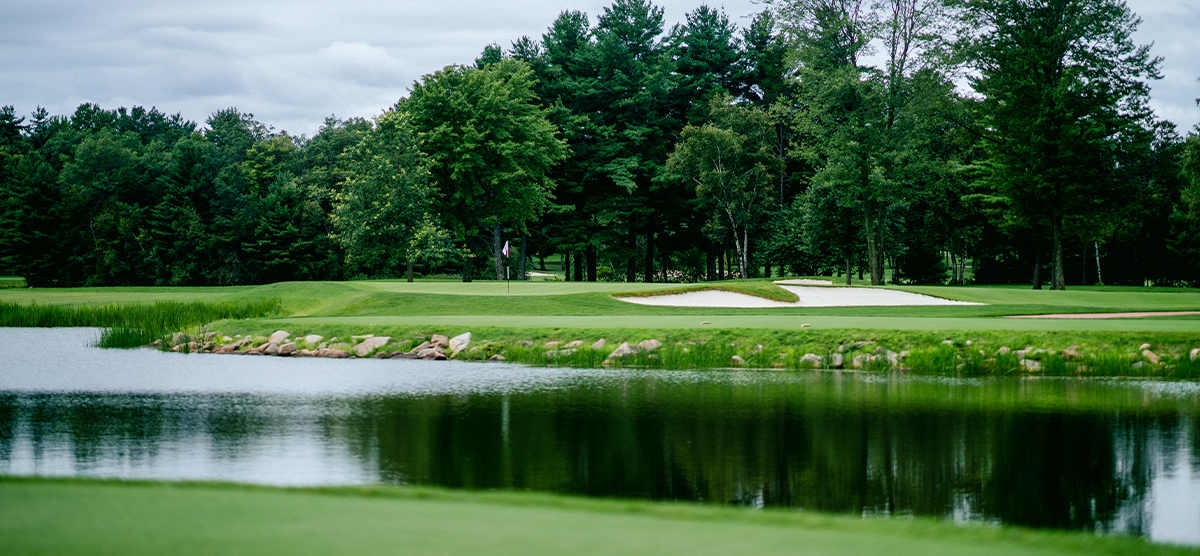 Water hazard and sand trap next to the putting green on the eleventh hole at SentryWorld