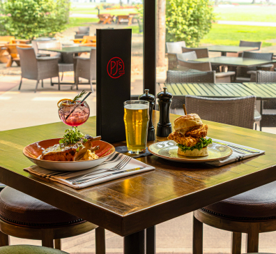 A table is set with two dishes and drinks at PJ's.