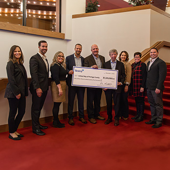 Group of Sentry representatives donating check to United Way