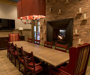 Long table next to the fireplace in the Celebration Room at PJ's at SentryWorld