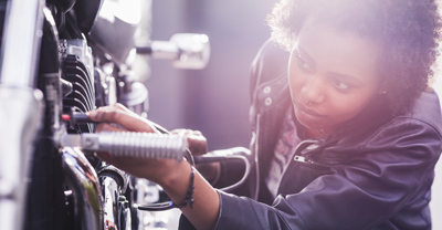 Woman inspecting motorcycle