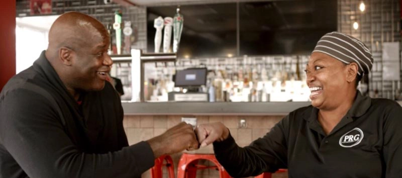 shaq-community-4 Shaquille O'Neal with an employee at a restaurant during digital series "Shaq Gives Back"