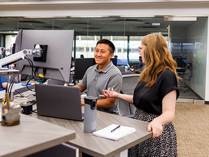 Co-workers collaborating at a stand up desk