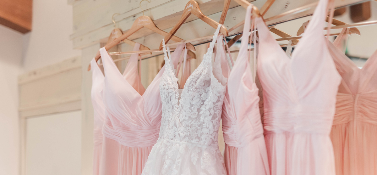 Wedding and bridesmaid dresses hanging. 