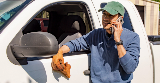 Man on cellphone outside of his truck