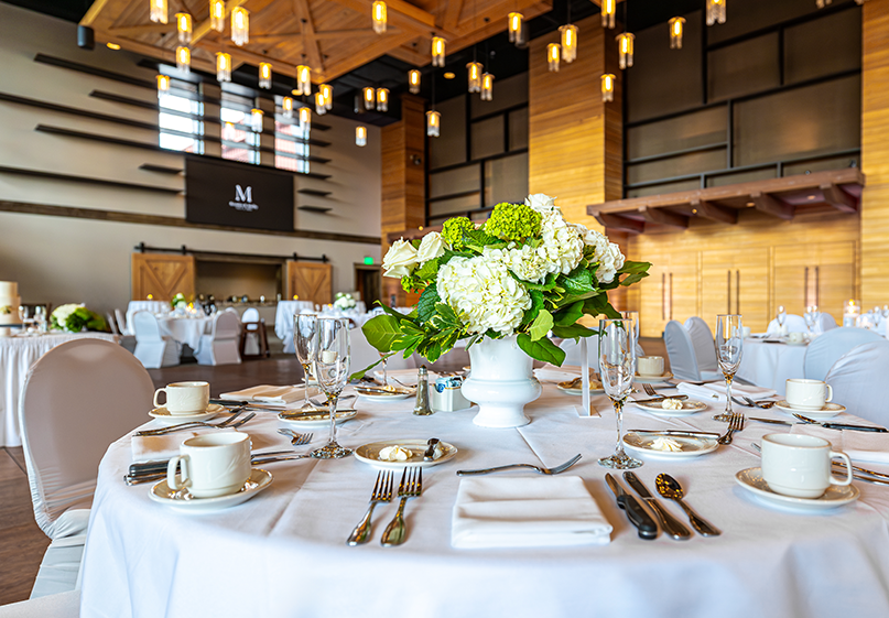 White table setting with white flowers in the atrium.