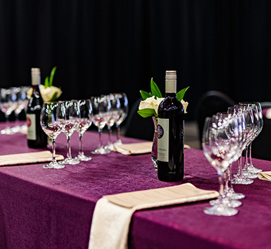 Wine bottles and glasses laid out on a table