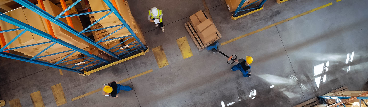 Aerial view people in hard hats working in factory