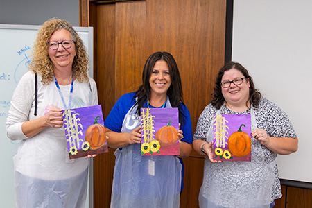 Associates participating in a painting workshop.