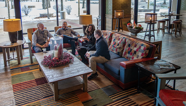 People sitting the couch and chairs in the PJ's Lounge