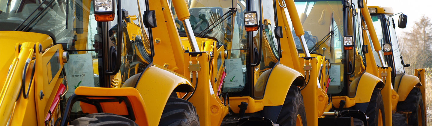 Large yellow industrial machines parked in a line.