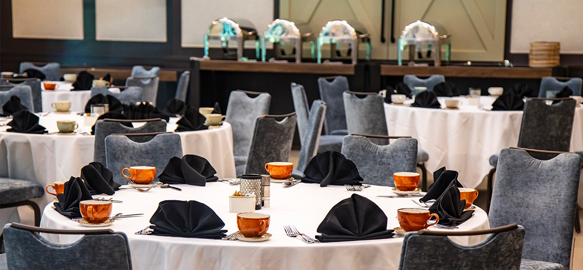 Round tables set for dining in a meeting room in The Inn at SentryWorld