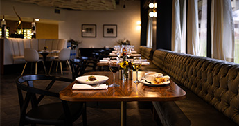 Two plates of food on a table in the Muse dining room. 