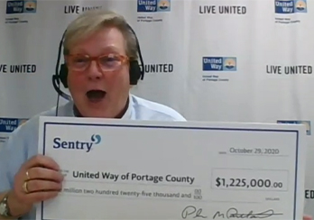 Sentry representative holding check for United Way