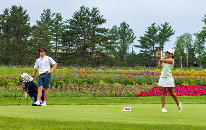 hero-usndp-672x427 Golfer with a caddie at a tee box on the golf course.