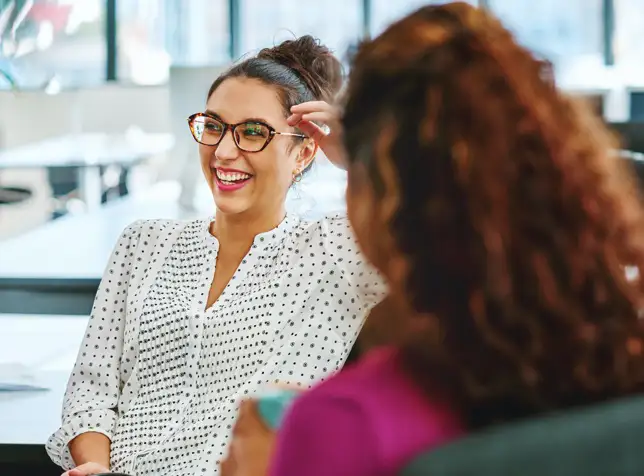 a woman smiling with coworkers