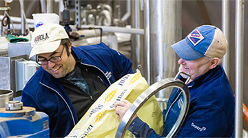 Two workers brewing the Hula Badger IPA