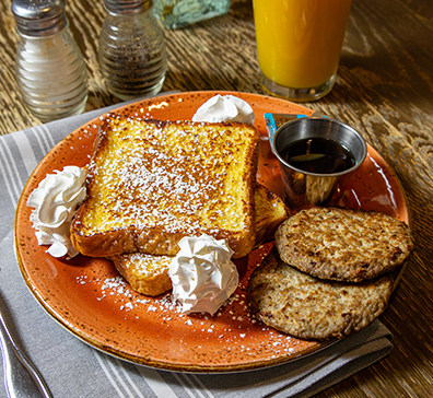 Plate of french toast and sausage. 