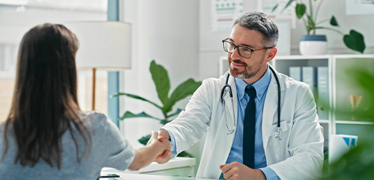 Doctor shaking hands with patient