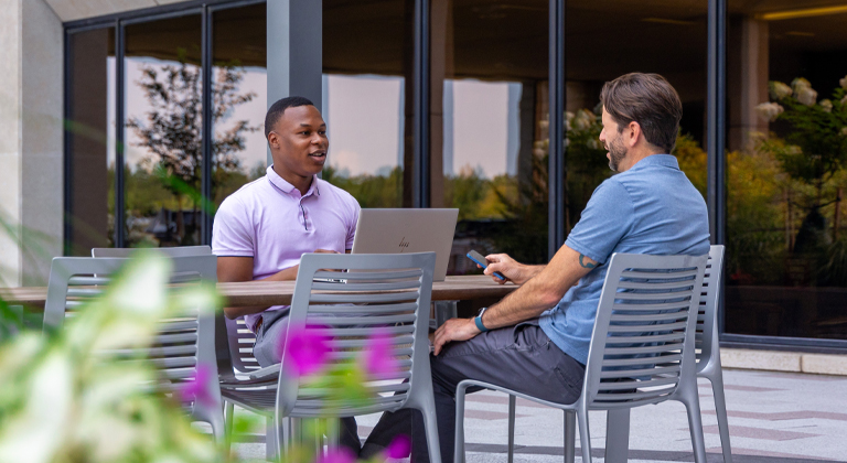 Two people talking at the Sentry corporate office