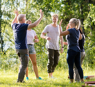 People celebrating in a circle in nature