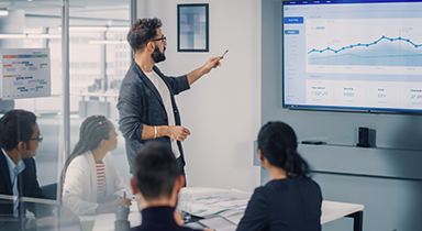 Man reviewing a chart with co-workers