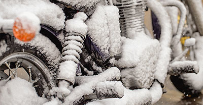 Motorcycle covered with snow