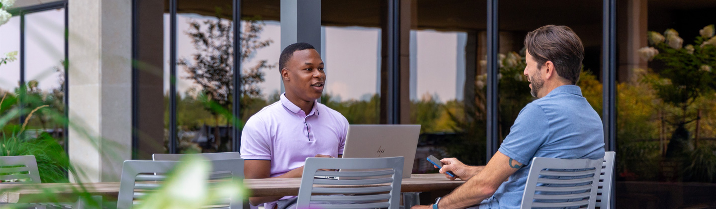 Two people talking at the Sentry corporate office