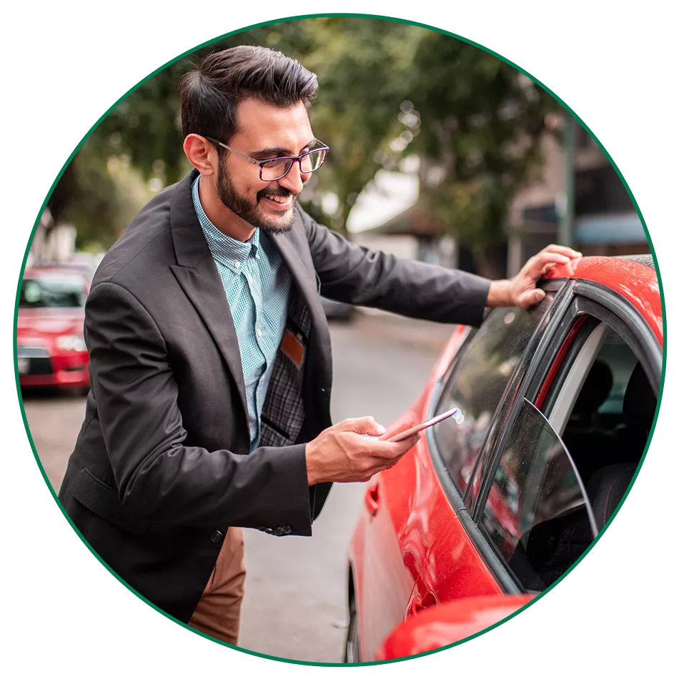 man-red-car-circle-image-LG man checking his phone next to red car