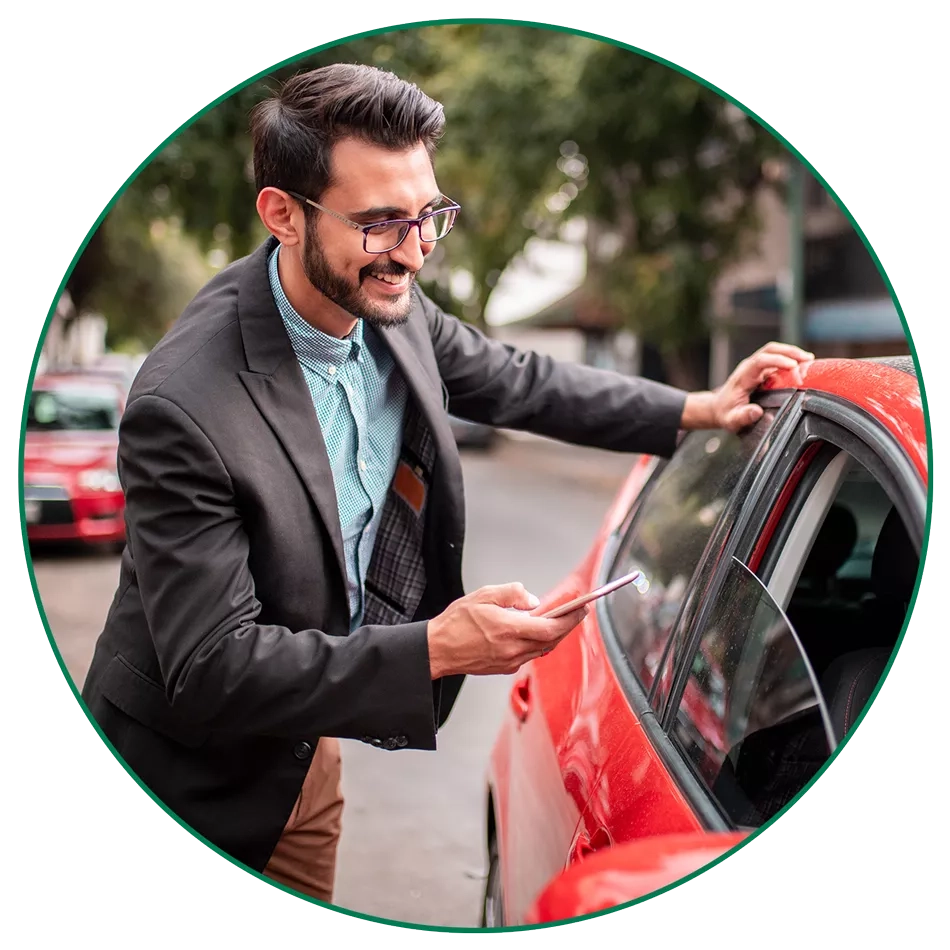 man-red-car-circle-image-LG man checking his phone next to red car