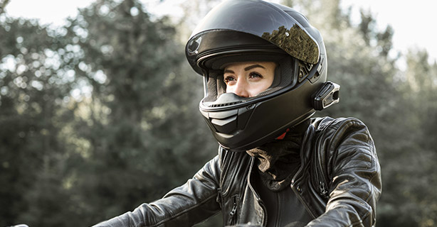 Woman wearing a helmet while riding a motorcycle