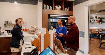 Two people ordering at the Library Cafe in The Inn at SentryWorld