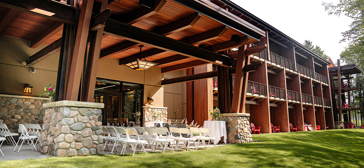 carousel-wedding-venue-inn-gathering-rooms-5-1200x556 Chairs set up for a wedding ceremony outside The Inn gathering rooms.