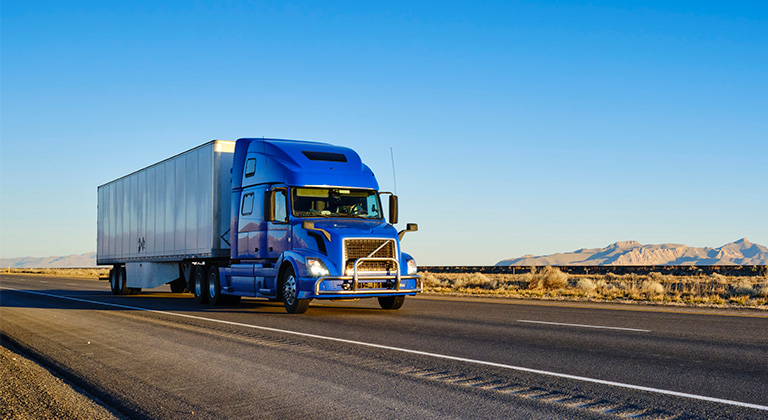 Semi-truck driving down a highway.