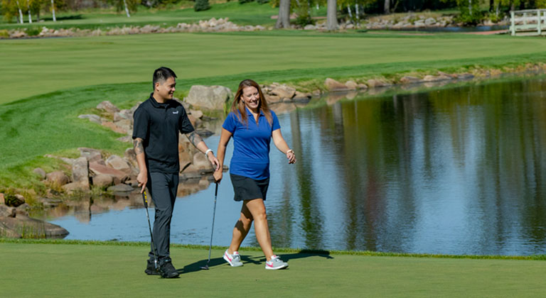 Golfers walking on golf course