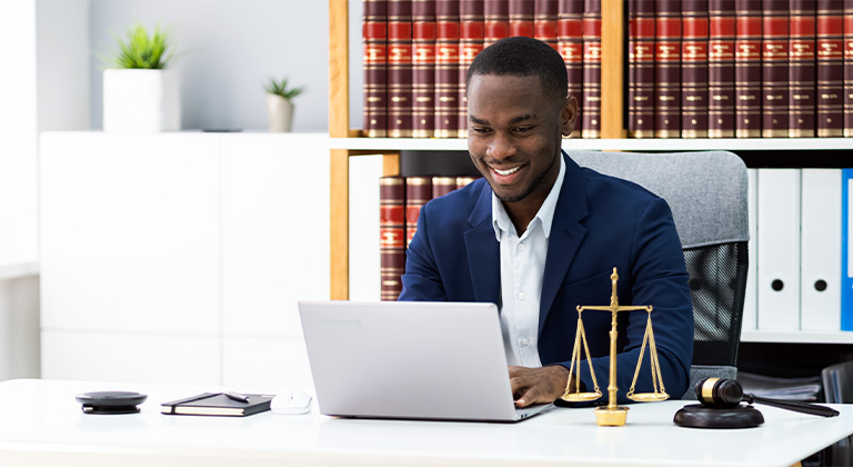 A legal associate working on a computer.