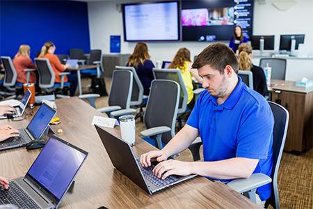 Sentry associate taking notes during a class at Sentry University