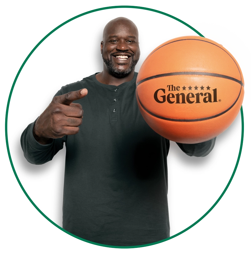 Shaq pointing and holding a basketball.
