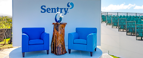 The Sentry golf tournament stage with blue colored chairs next to the tournament trophy