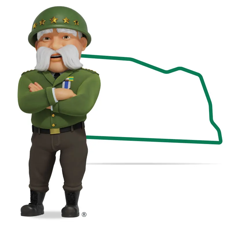 The General standing in front of Nebraska with his arms crossed and a smile.