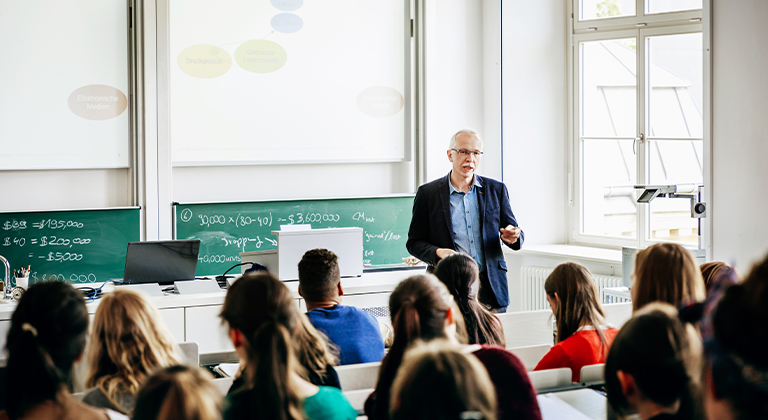 Teacher talking in front of a class