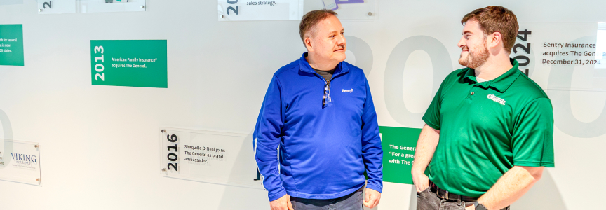 Two men standing in front of a timeline